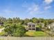 Aerial view of a two-story house with screened patios surrounded by lush greenery at 4899 Meadow Dr, St Cloud, FL 34772