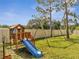 Backyard with swing set, playhouse and slide providing a fun outdoor play area at 4899 Meadow Dr, St Cloud, FL 34772