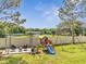Backyard featuring a swing set, playhouse, patio and seating area at 4899 Meadow Dr, St Cloud, FL 34772