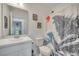 Bathroom featuring a Godzilla themed shower curtain and white vanity at 4899 Meadow Dr, St Cloud, FL 34772
