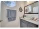 Chic half bathroom with a vessel sink, granite countertops, and decorative mirror at 4899 Meadow Dr, St Cloud, FL 34772