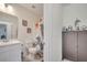 Bathroom with a Godzilla themed shower curtain and decorative cabinet at 4899 Meadow Dr, St Cloud, FL 34772