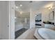 Bright bathroom featuring a glass shower and tub with tile flooring and stone countertops at 4899 Meadow Dr, St Cloud, FL 34772