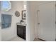 Stylish powder room with dark vanity, vessel sink, granite countertop, and modern decor at 4899 Meadow Dr, St Cloud, FL 34772