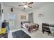 Brightly lit bedroom featuring a dinosaur theme, desk, and access to a balcony at 4899 Meadow Dr, St Cloud, FL 34772