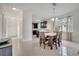 Bright dining area featuring a wooden table set, modern lighting, and white tile floors at 4899 Meadow Dr, St Cloud, FL 34772