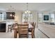 Dining room with large windows and a view of the connected kitchen at 4899 Meadow Dr, St Cloud, FL 34772