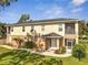 Charming two-story home with landscaped yard and screened-in porch under blue sky at 4899 Meadow Dr, St Cloud, FL 34772