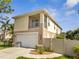 Charming two-story home featuring an attached garage, balcony, and manicured landscaping at 4899 Meadow Dr, St Cloud, FL 34772