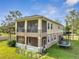 Two-story home with screened patios and outdoor play area featuring a trampoline at 4899 Meadow Dr, St Cloud, FL 34772