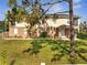 Inviting two-story home with a well-manicured lawn and mature trees enhancing its curb appeal at 4899 Meadow Dr, St Cloud, FL 34772
