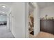 Hallway with neutral tones, showcasing an open bathroom and access to living spaces at 4899 Meadow Dr, St Cloud, FL 34772