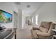 Hallway with a bonus space featuring a recliner and desk and television at 4899 Meadow Dr, St Cloud, FL 34772