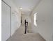 Bright hallway features carpeted floors, neutral walls, and easy access to the staircase and bedrooms at 4899 Meadow Dr, St Cloud, FL 34772