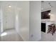 Hallway leading to the kitchen area with stainless steel appliances and a breakfast bar at 4899 Meadow Dr, St Cloud, FL 34772