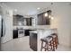 Modern kitchen featuring dark cabinets, granite countertops, and stainless steel appliances at 4899 Meadow Dr, St Cloud, FL 34772