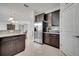 Stylish kitchen showcasing dark wood cabinets, stainless steel appliances, and granite countertops at 4899 Meadow Dr, St Cloud, FL 34772