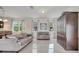 Beautiful living room with large windows, tile floors, and stylish furnishings at 4899 Meadow Dr, St Cloud, FL 34772
