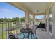 Outdoor patio furniture with nature view and a table for outdoor relaxation at 4899 Meadow Dr, St Cloud, FL 34772