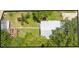 Aerial view of the property showcasing the layout of the house, yard, and surrounding trees at 517 Carolina Ave, St Cloud, FL 34769