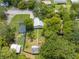 Aerial view of a home with a large backyard, surrounded by lush greenery and other houses at 517 Carolina Ave, St Cloud, FL 34769