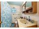 Bathroom with marble sink, turtle-themed shower curtain, and decorative accents at 517 Carolina Ave, St Cloud, FL 34769