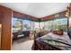Bedroom with wood paneled walls, a window with blinds, and a bed with a floral comforter at 517 Carolina Ave, St Cloud, FL 34769