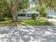 Well-maintained single-story home with a lush green lawn and mature trees creating a picturesque setting at 517 Carolina Ave, St Cloud, FL 34769