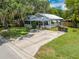 Charming single-story home with a welcoming front yard, lush lawn, and metal roof at 517 Carolina Ave, St Cloud, FL 34769