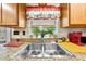 Bright kitchen sink area with natural light, greenery, and ample counter space for convenient food preparation at 517 Carolina Ave, St Cloud, FL 34769