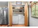 Functional laundry area with modern appliances, ample storage, and easy access to the outdoors at 517 Carolina Ave, St Cloud, FL 34769