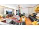 Comfortable living room with a TV, cozy seating, and an open doorway leading to another room at 517 Carolina Ave, St Cloud, FL 34769