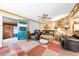 Cozy living room with comfortable leather seating, brick fireplace, and a colorful area rug at 517 Carolina Ave, St Cloud, FL 34769