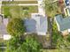 An aerial view of the home shows the roof, landscaping, nearby streets, and surrounding neighborhood at 5452 Higgins Way, Orlando, FL 32808