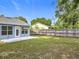 A bright outdoor space with well-maintained grass, a new patio, and light-blue siding on the home at 5452 Higgins Way, Orlando, FL 32808