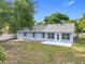 The back exterior features light blue siding, white trim, and a concrete patio, perfect for outdoor enjoyment at 5452 Higgins Way, Orlando, FL 32808