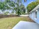 A spacious backyard with a well-maintained lawn, mature trees, and a sturdy wooden fence at 5452 Higgins Way, Orlando, FL 32808