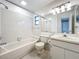 Clean bathroom with white tile, bathtub, and vanity sink at 5452 Higgins Way, Orlando, FL 32808