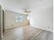 Spacious bedroom with wood-look flooring and a window view at 5452 Higgins Way, Orlando, FL 32808