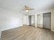Bright bedroom with mirrored closet doors and wood-look flooring at 5452 Higgins Way, Orlando, FL 32808