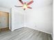Bright bedroom with ceiling fan, wood-look floors and closet space at 5452 Higgins Way, Orlando, FL 32808