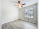 Bright bedroom featuring wood floors, a ceiling fan, and a sun-filled window at 5452 Higgins Way, Orlando, FL 32808