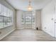 Sunny dining area with bay window and light, wood-look flooring at 5452 Higgins Way, Orlando, FL 32808