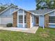 Light blue single-Gathering home with brick accents, manicured lawn and well-lit entryway at 5452 Higgins Way, Orlando, FL 32808