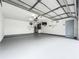Clean, painted garage with painted floor, ample lighting, and practical storage features at 5452 Higgins Way, Orlando, FL 32808