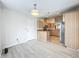 Open kitchen with wood cabinetry, stainless appliances, and plenty of natural light at 5452 Higgins Way, Orlando, FL 32808