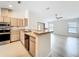 Bright kitchen with wood cabinets, stainless steel appliances, and an open layout to the living area at 5452 Higgins Way, Orlando, FL 32808
