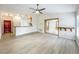 Spacious open-concept living room with light wood floors and access to other living spaces at 5452 Higgins Way, Orlando, FL 32808