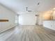 Spacious living room with wood floors, fan, and bright, sun-filled windows at 5452 Higgins Way, Orlando, FL 32808