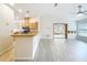 Open-concept living space with kitchen featuring wood cabinets and easy access to other rooms at 5452 Higgins Way, Orlando, FL 32808